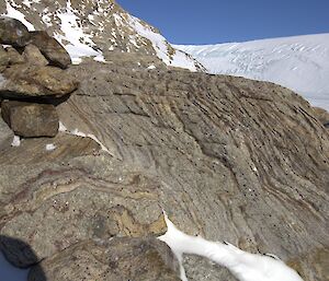 Patterns and lines can be seen in the faces of the rocks piled into a cairn