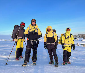 Four people in Antarctic hiking gear