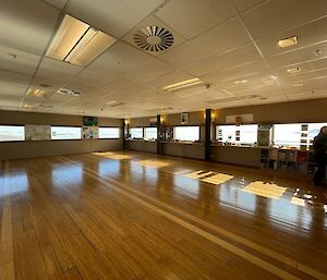 A very shiny bamboo floor in the empty station dining hall.