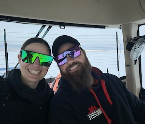 Two expeditioners sit in a tractor.