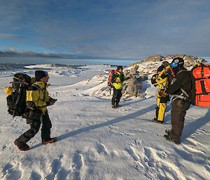 Expeditioners discussing the condition of the sea ice prior to crossing over it by foot
