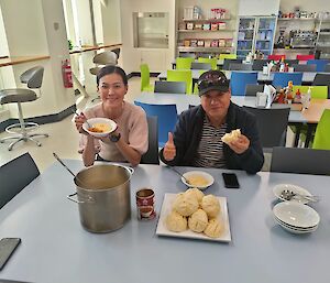 Chef and a happy customer eating homemade Chinese food