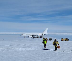 Expeditioners disembark the white Airbus A319 onto the snow at Wilkins aerodrome Antarctica