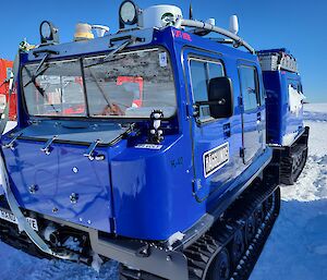 A stuffed cat toy on a blue Hagglunds vehicle outside the Casey red shed