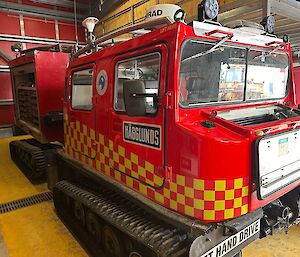 A red Hägglunds with yellow emergency checkering