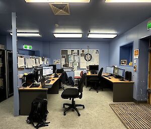 a corner office space with three meteorologists desks.