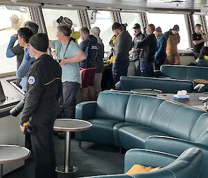 Expeditioners looking out over the sea at Davis Station on arrival