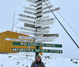 Expeditioner sitting next to the Davis sign