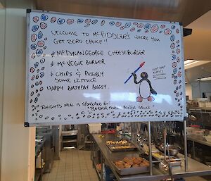 A menu written on a large white board.