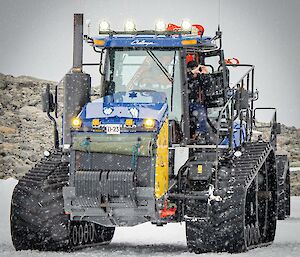 A tractor convoy driving on snow