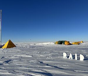 Camp set up on snow with ice drill