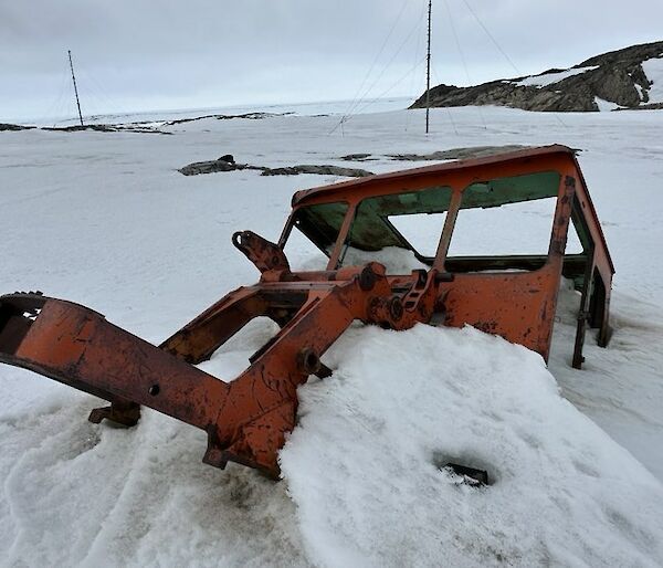 Old tractor buried in snow