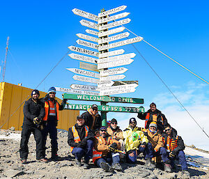 Our work team standing at the Davis Sign