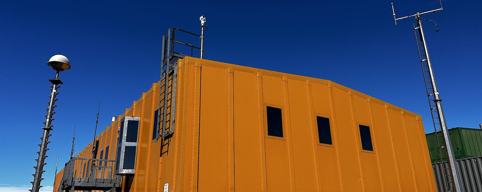 Looking up at the Yellow ops building with blue sky behind