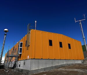 Looking up at the Yellow ops building with blue sky behind