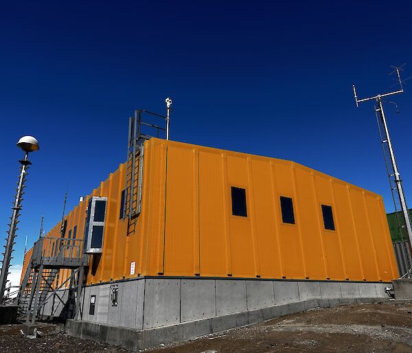 Looking up at the Yellow ops building with blue sky behind