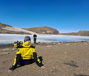 Station leader sitting on a rock taking in the views
