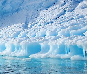 Blue ice appears to flow into the water