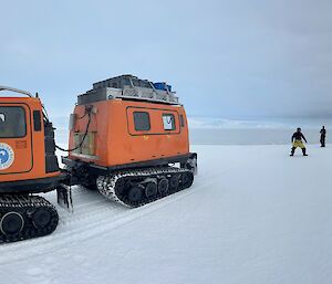 Orange and Blue Hagglunds on Seaice travelling to rookery.