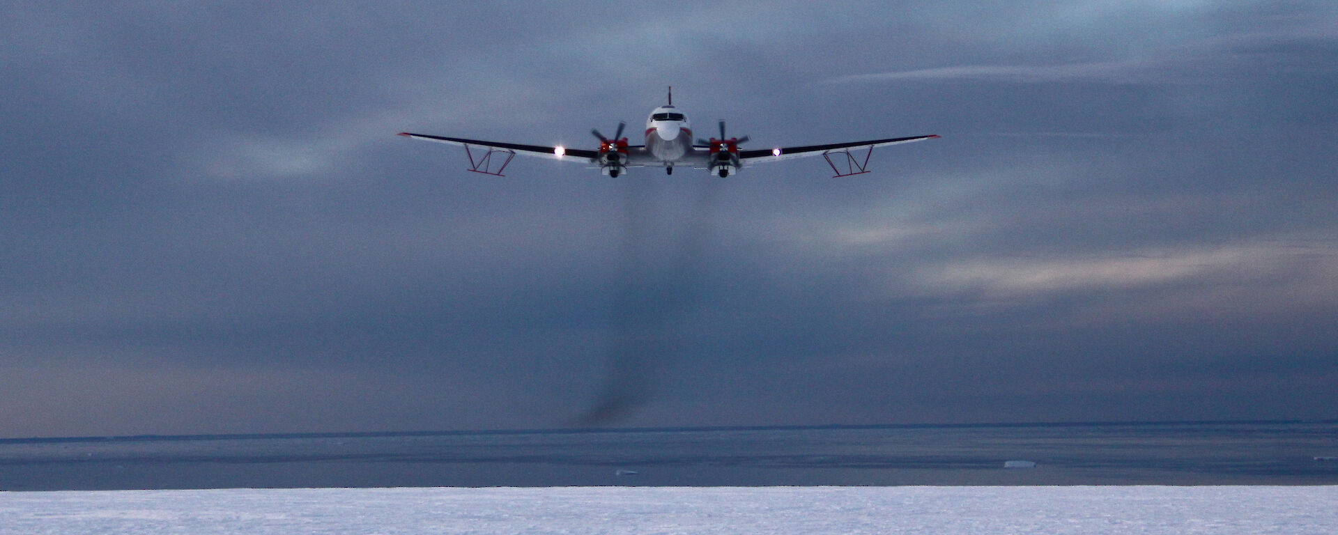 Plane with two propellers in the cloudy sky