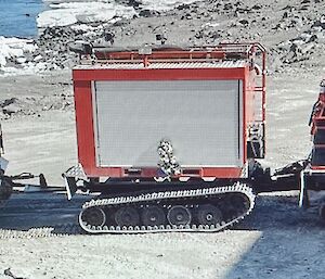 Fire hagg from left to right tracked trailer with Santa Sleigh with expeditioners in costume, tracked trailer with fire hose and pump enclosure, tracked Fire Hagg with costumed expeditioner out of roof hatch.