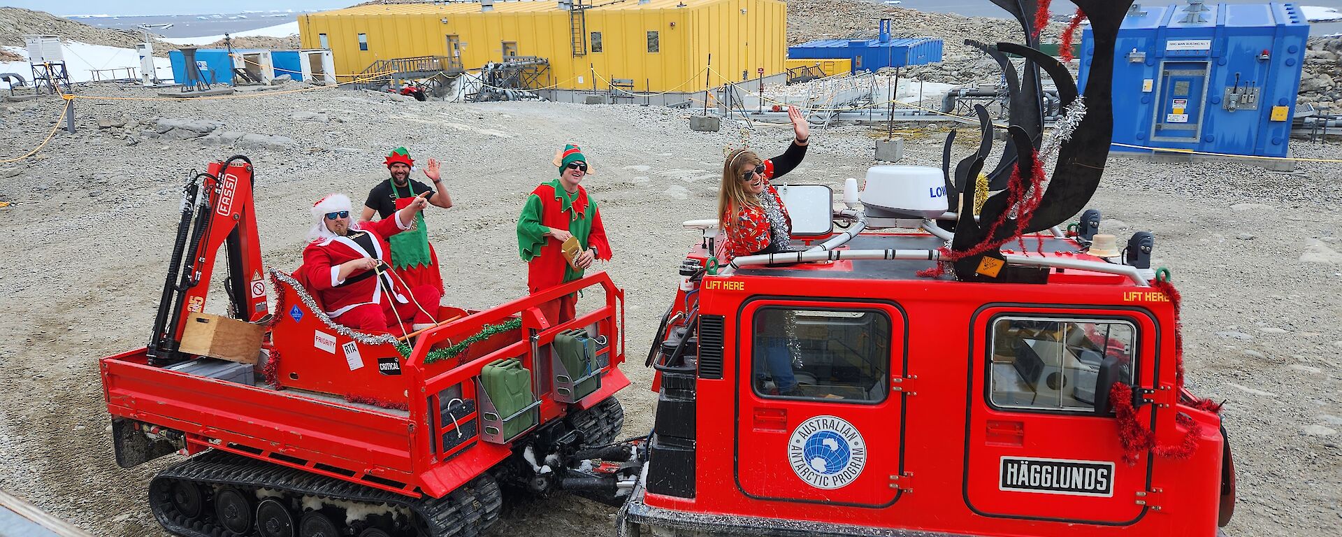 Red Hagglund oversnow vehicle decorated as Santas reindeer.