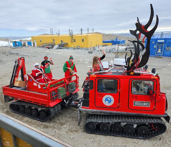 Red Hagglund oversnow vehicle decorated as Santas reindeer.