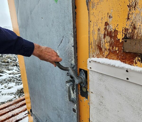 galvanized steel handle on the exterior of an old observation hut