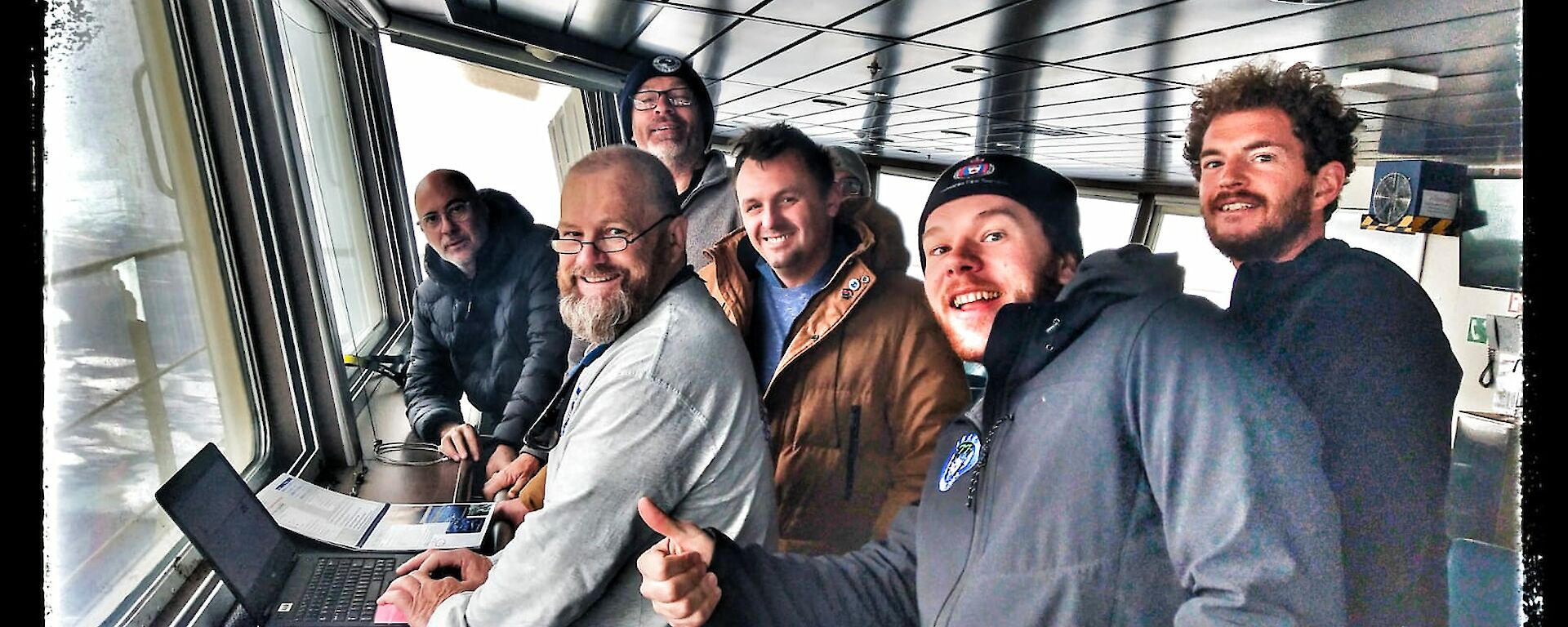 Expeditioners gathered on the observation deck of Nuyina