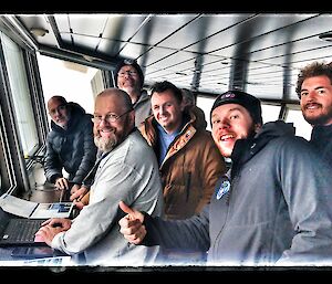 Expeditioners gathered on the observation deck of Nuyina