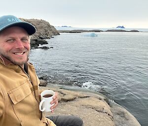 Marcus having a cuppa by the sea