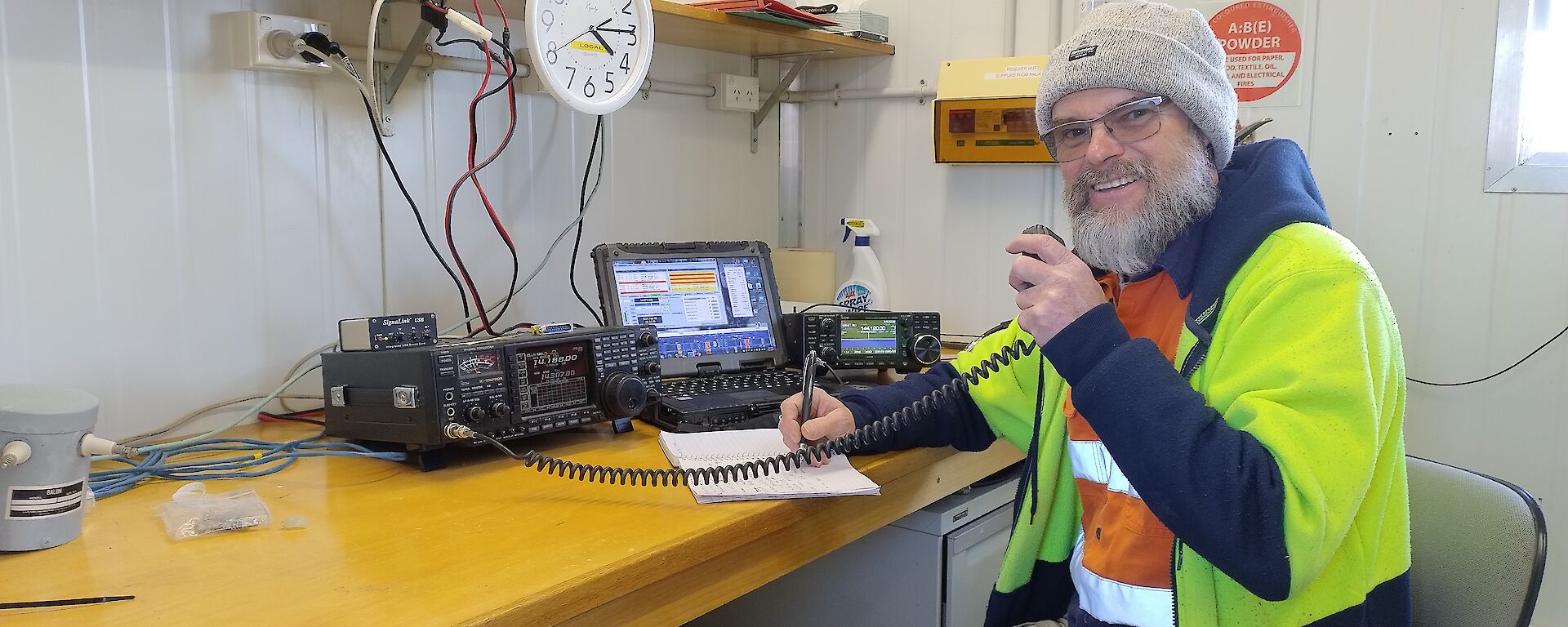 Dave speaking into a fixed radio set at the operations console