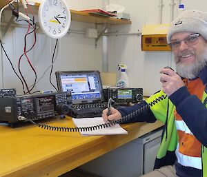 Dave speaking into a fixed radio set at the operations console