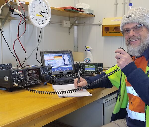 Dave speaking into a fixed radio set at the operations console