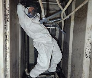 Plumber inside confined space having a dance