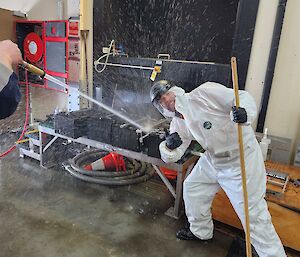 Expeditioners washing down plumbing equipment