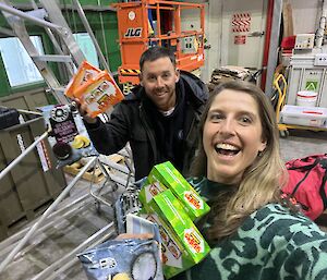 happy expeditioners holding boxes of snacks in the supply store
