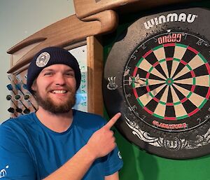 Marcus standing at the dart board after scoring well