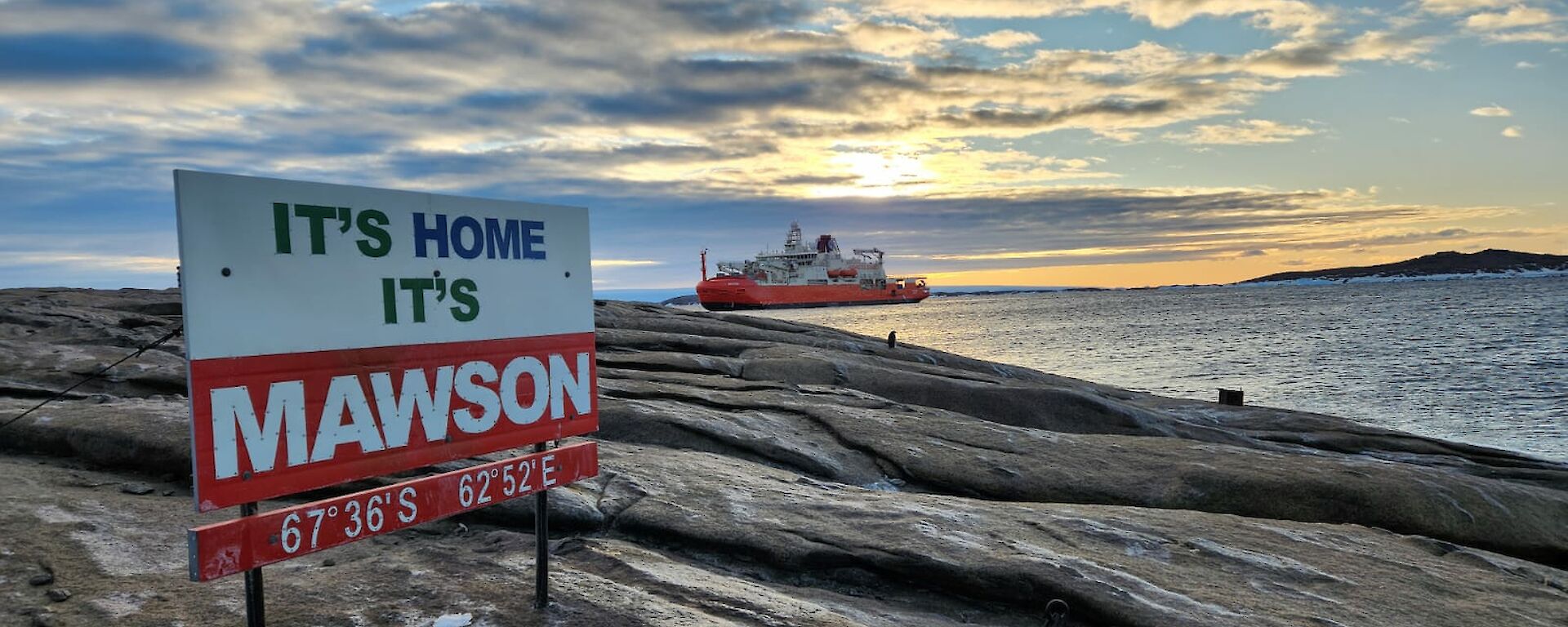 Nuyina at the end of West Arm in front of the Mawson sign