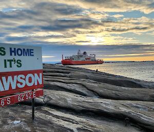 Nuyina at the end of West Arm in front of the Mawson sign