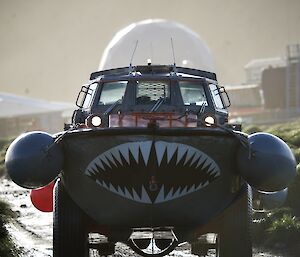 A Lighter, Amphibious Resupply, Cargo vessel with painted teeth on the front.