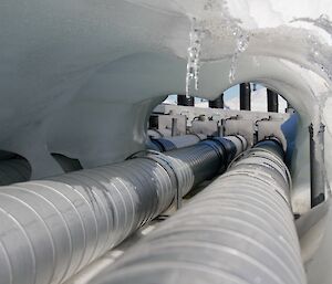 two silver pipes with an ice cave over the top