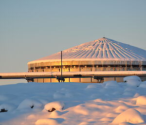 A big round silver tank surrounded by snow.