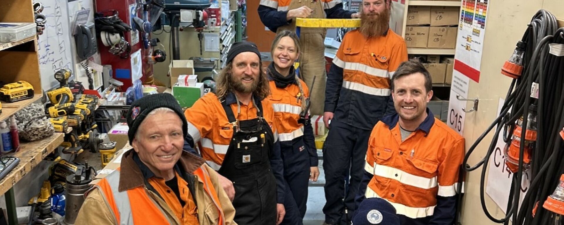 Seven Casey station electricians pose for a photo in workshop