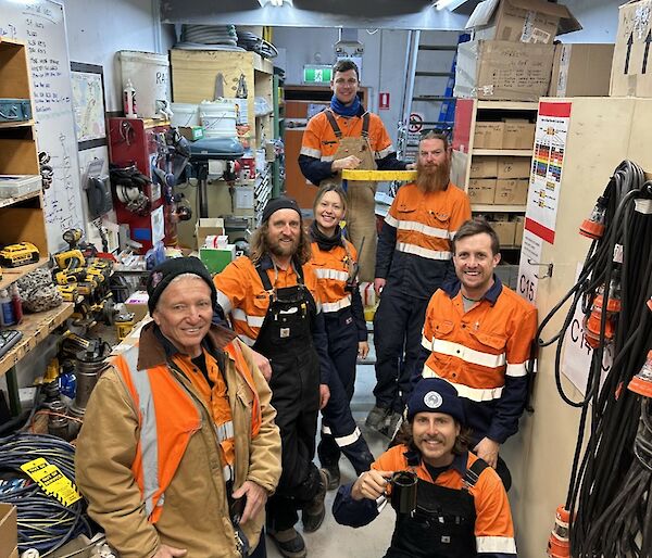 Seven Casey station electricians pose for a photo in workshop