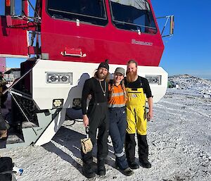 3 expeditioners in front of the bus transport departing for the aerodrome