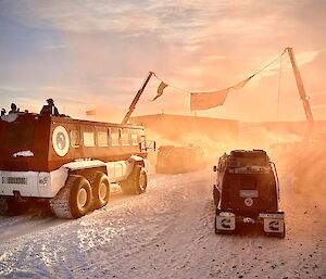 A view of the vehicles departing under a flown Australian flag into the warm morning sunrays.