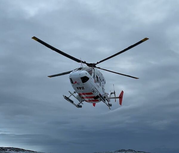 A helicopter nearly on the ground at Mawson station recently