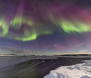 Purple red green auroral lights over Mawson on the 25th March