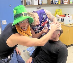 Expeditioners cutting each others hair at Mawson station recently